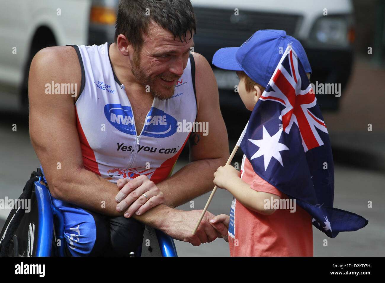 Jan. 26, 2013 - Sydney, Australia - January 26, 2013 - Sydney, Australia - London 2012 Paralympics medal winner, Kurt Fearnley, got a congratulation from his kid fans after he won the first place of GIO Oz Day 10K wheelchair race, as a part of celebrating Australia Day 2013,on January 26,2013 in Sydney, Australia. Australia Day, formerly known as Foundation Day, is the official national day of Australia and is celebrated annually on January 26 to commemorate the arrival of the first fleet to Sydney in 1788. Australia Day today is a celebration of diversity and tolerance in Australian society.  Stock Photo