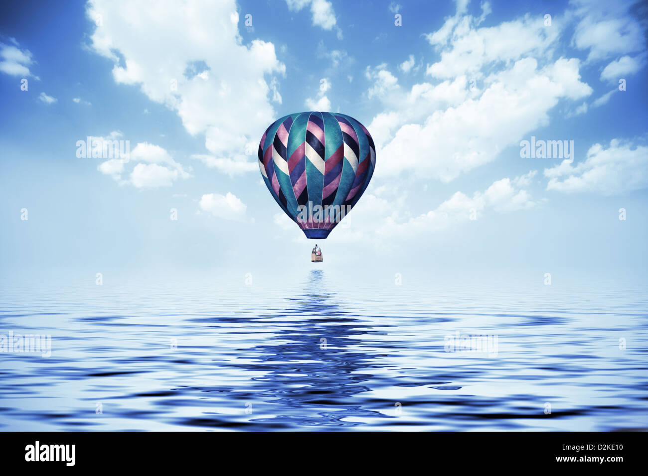 balloon flying low over the water Stock Photo