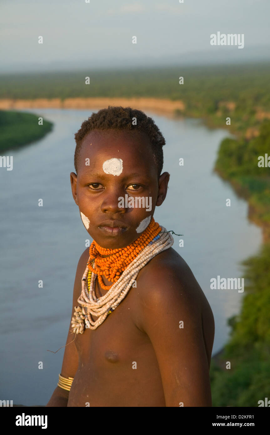 Portrait of decorated Kara woman on bluff with Omo River below-close up Stock Photo