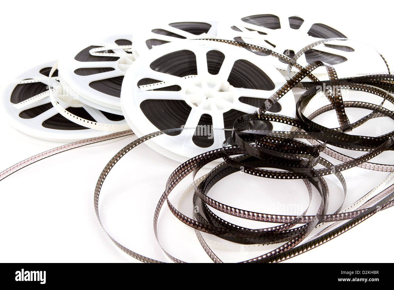 Obsolete rolls of old 8mm movie film are wound on white plastic reels. Stock Photo