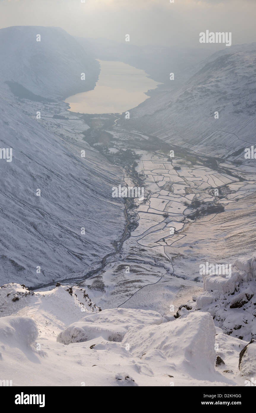 View over Wasdale and Wast Water from next to the Westmorland Cairn on the summit of Great Gable in winter in the English Lakes Stock Photo