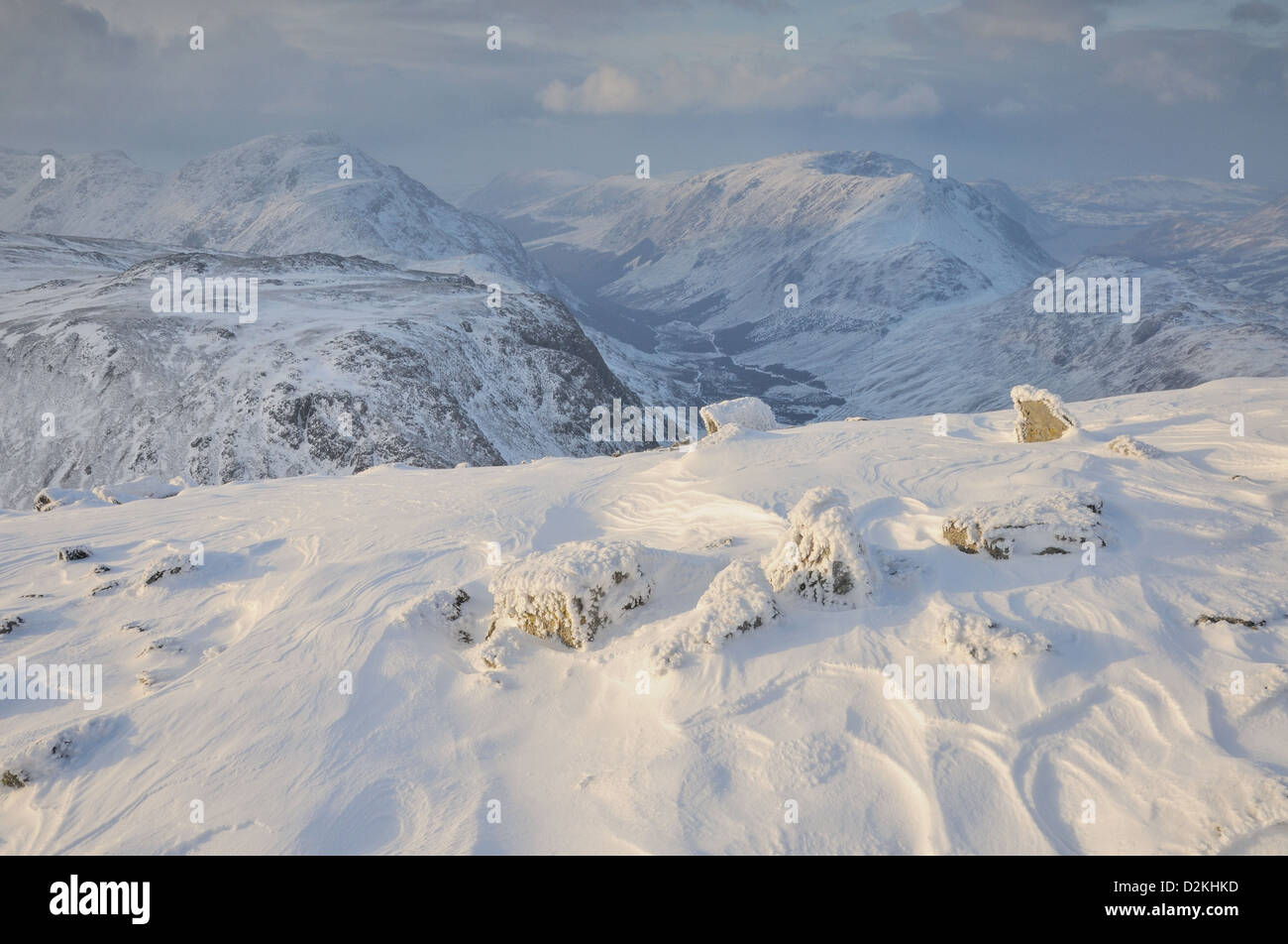 Frozen rocks and snow patterns on the summit of Great Gable in the English Lake District. Ennerdale and Pillar in background Stock Photo