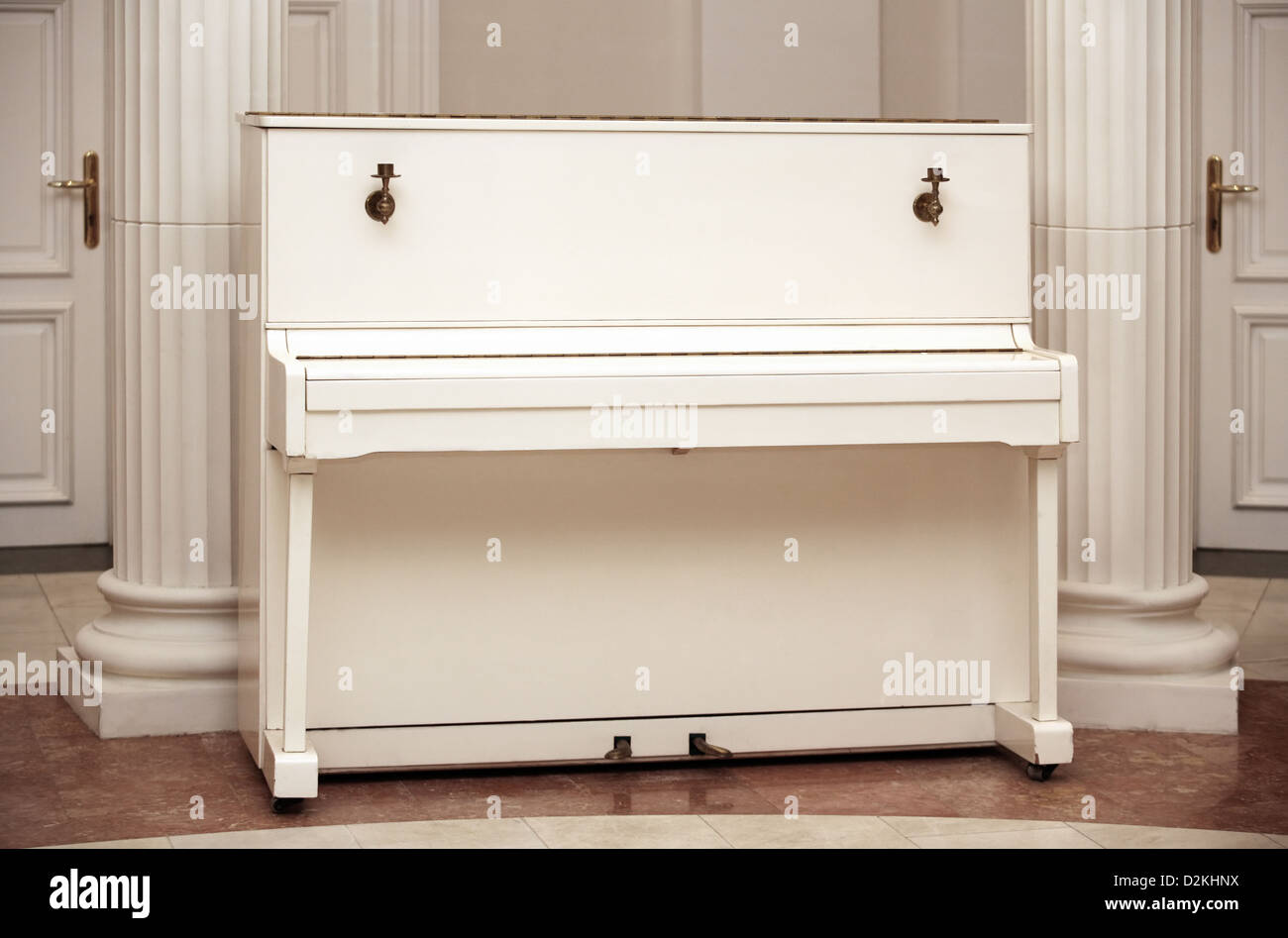 The white piano in an interior Stock Photo - Alamy