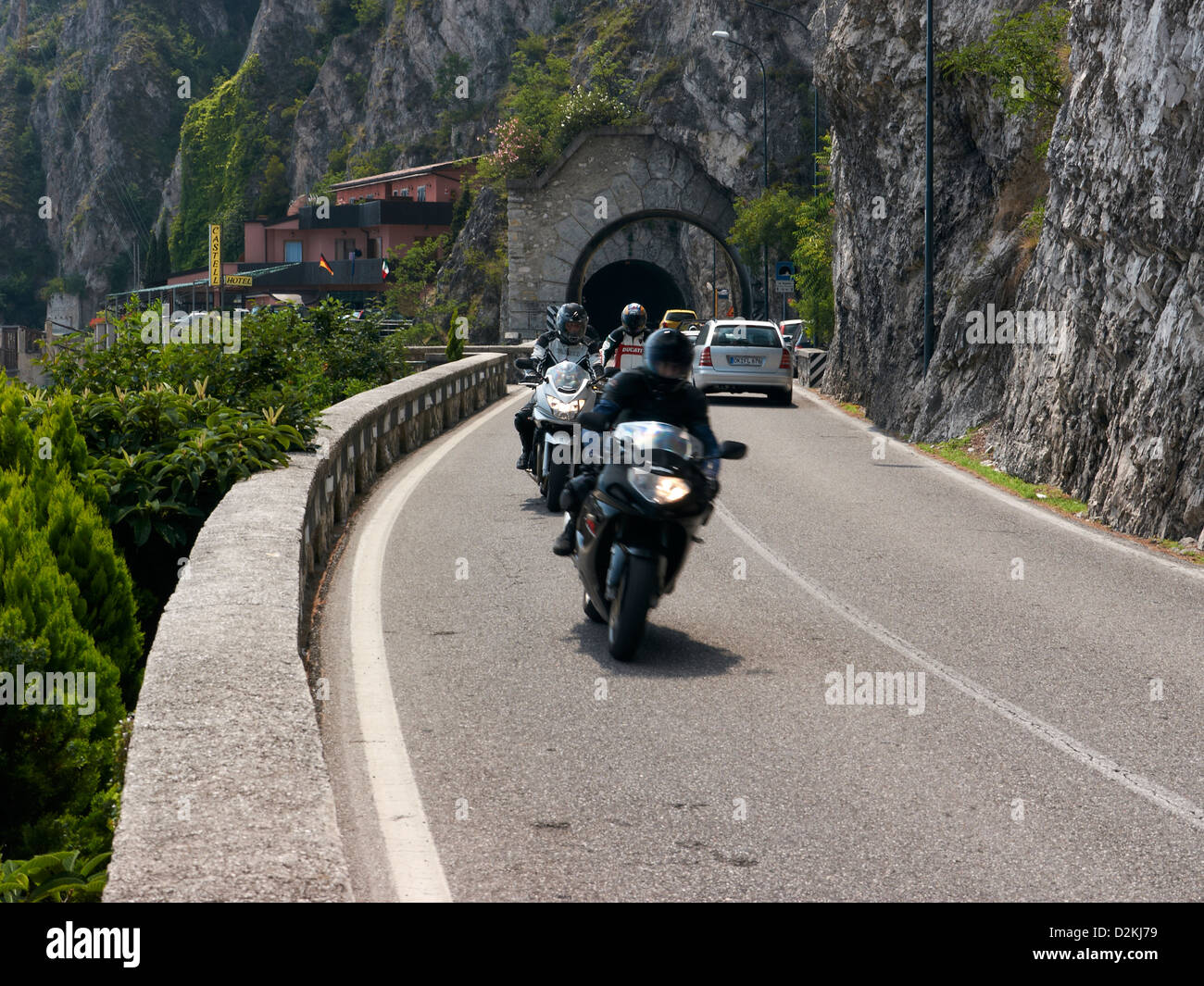 Motorcyclists coming out of tunnel Stock Photo