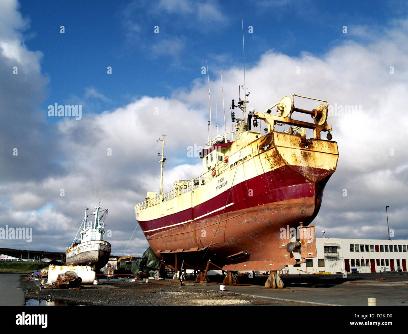 Two fishing boats ashore at a ship yard in Kevlavik, Iceland Stock Photo