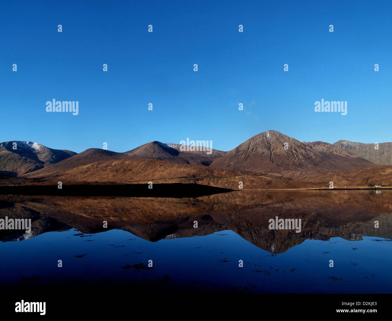 The Red Cuillin mountains of Skye reflected in a Scottish Sea Loch Stock Photo