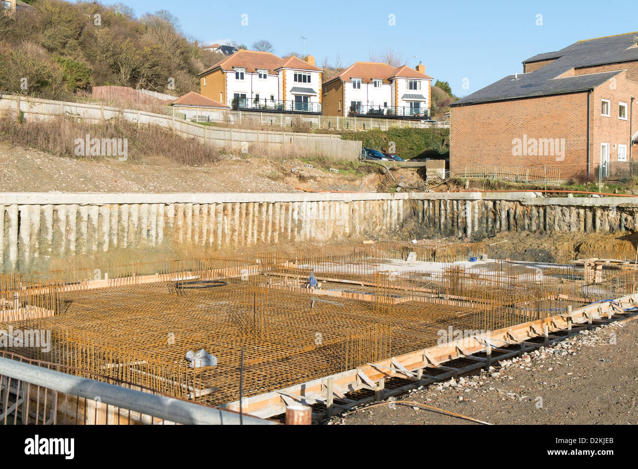 Construction site where reinforced concrete piles have been built into the bank and steel reinforcing rods have been laid. Stock Photo