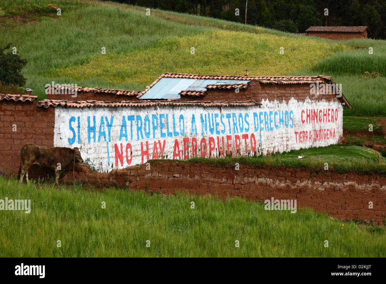 Writing on farm wall protesting against plans to build an international airport near village of Chinchero , near Cusco , Peru Stock Photo