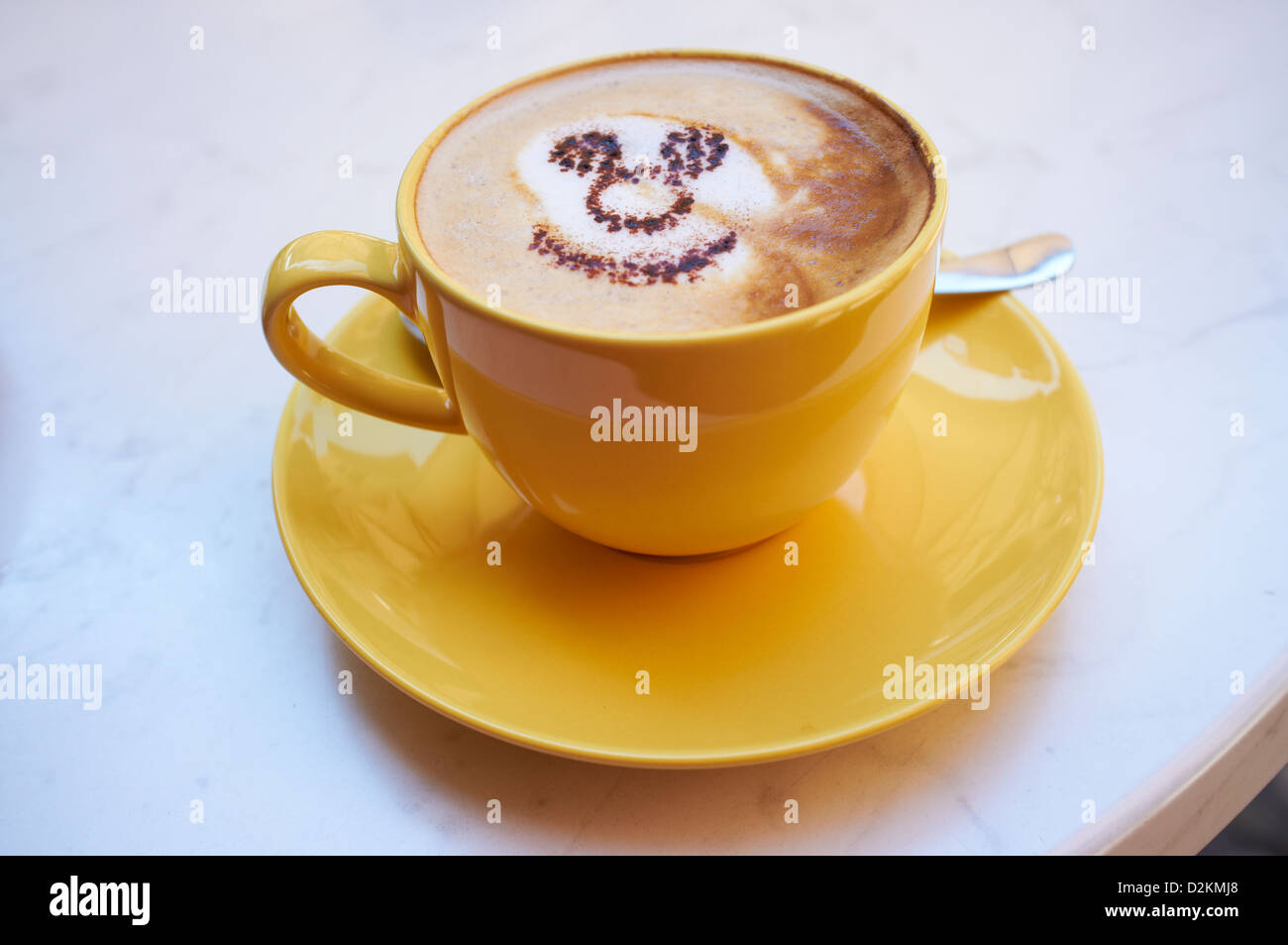 Cup of coffee with smiley face made of cocoa Stock Photo