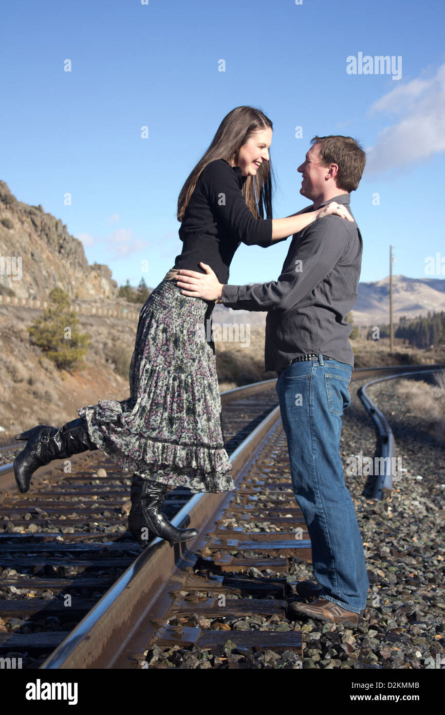 a young couple on the train tracks Stock Photo - Alamy
