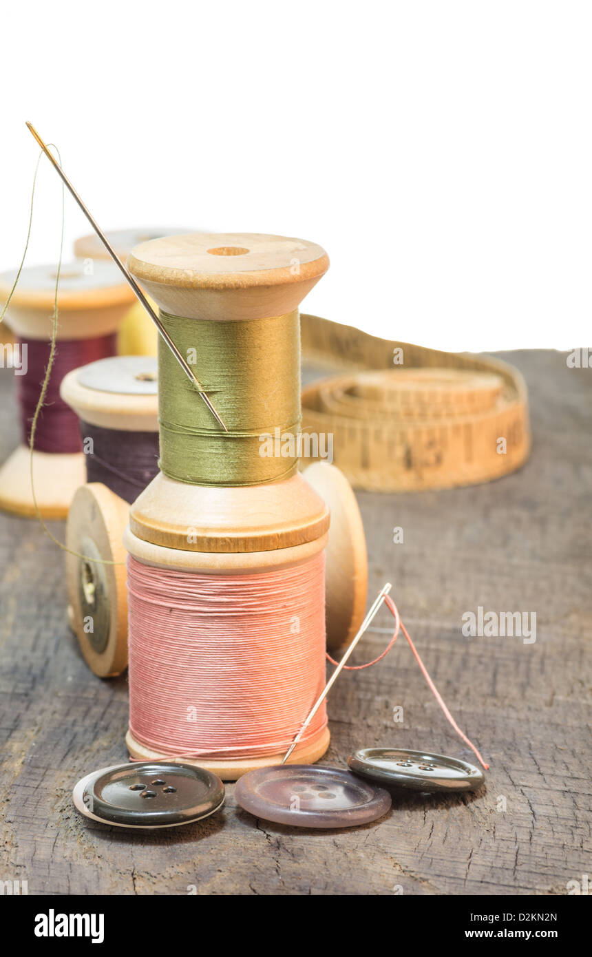 Buttons and sewing thread witha needle and tape Stock Photo - Alamy