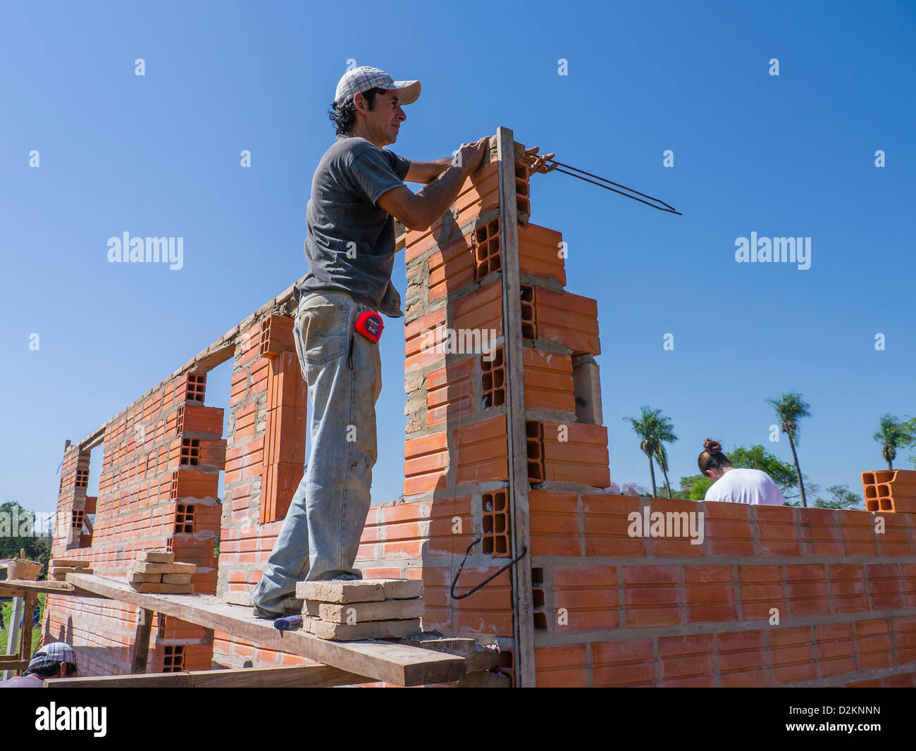 The head mason works on a Habitat for Humanity house building site in Luque, Paraguay. Stock Photo