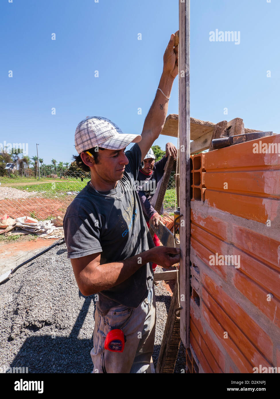 The head mason works on a Habitat for Humanity house building site in Luque, Paraguay. Stock Photo