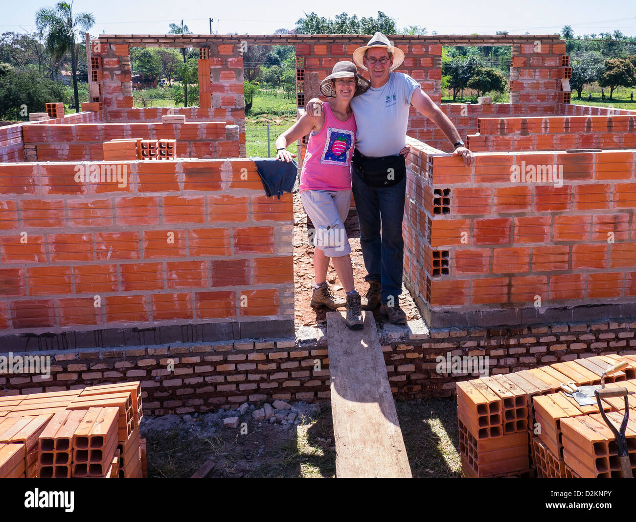 Two volunteers from the United States pause from their work on a Habitat for Humanity house building site in Luque, Paraguay. Stock Photo