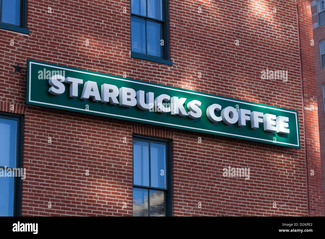 Starbucks sign on brick wall Stock Photo