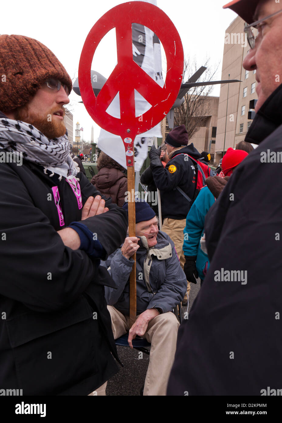 Red peace sign held up in demonstration Stock Photo