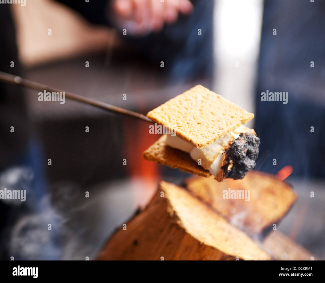 S'mores. Graham cracker, chocolate, and marshmallow, roasted over a campfire. Stock Photo
