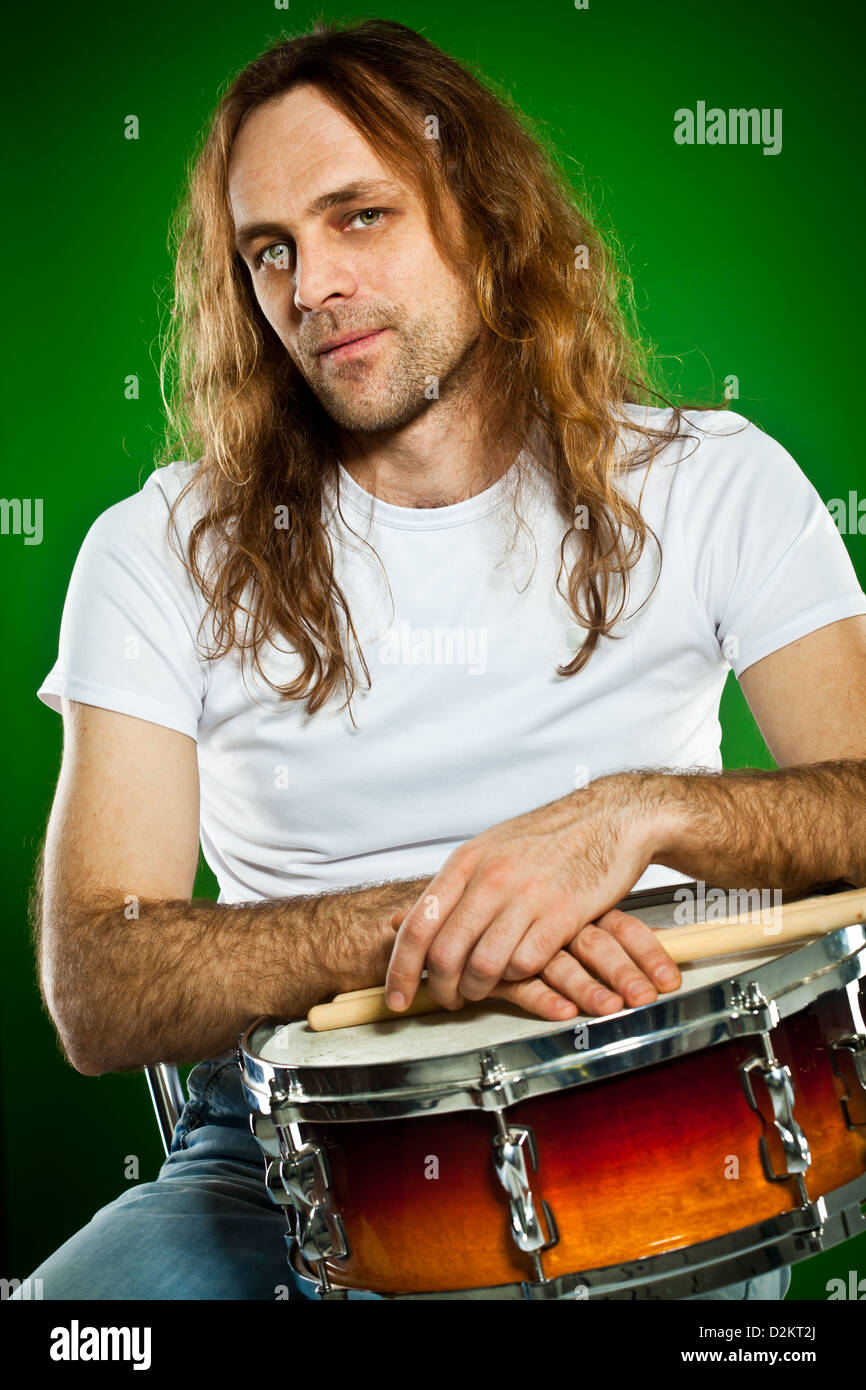 Portrait of the drummer man on a green background Stock Photo Alamy