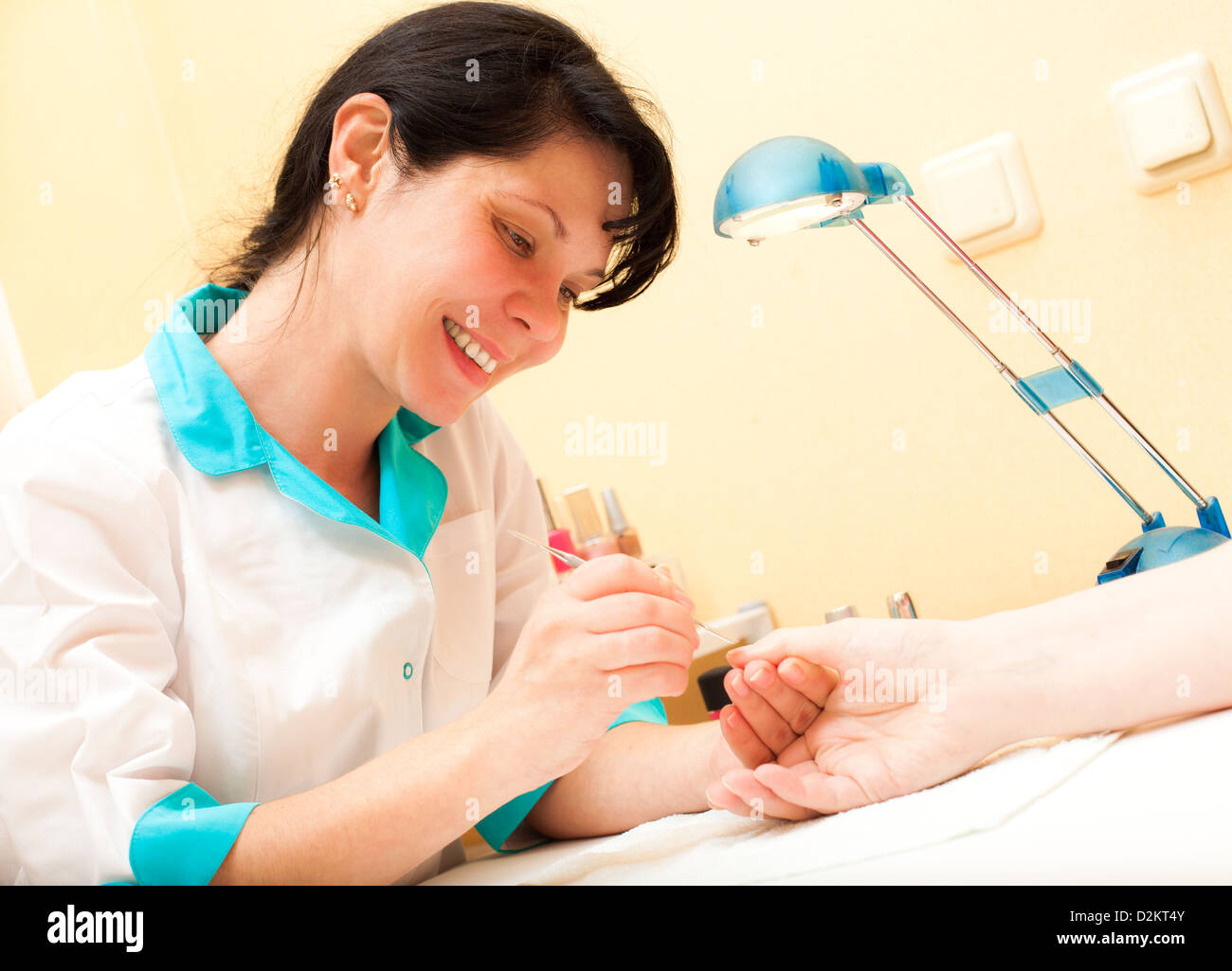 Manicure. Care of fingers of hands, cleaning, covering a varnish of nails. Stock Photo