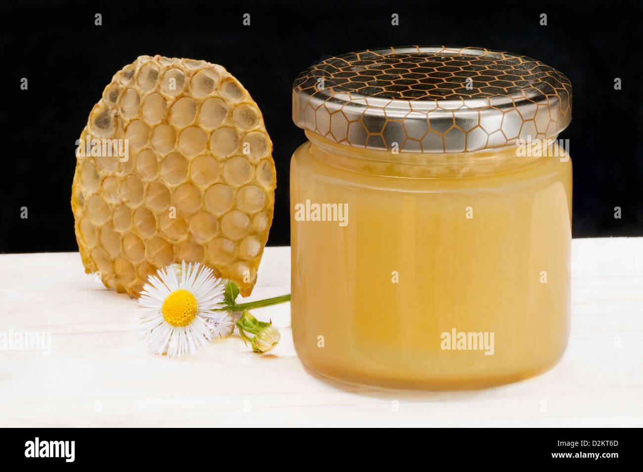 Honey comb, daisy flower, honey glass jar Stock Photo