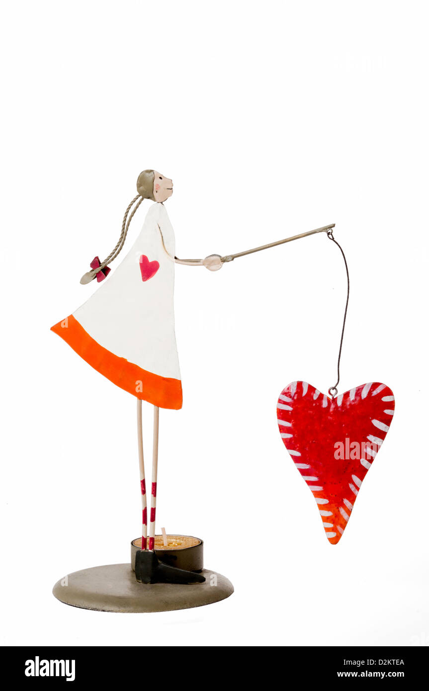 Decorative figurine, girl fishing heart Stock Photo