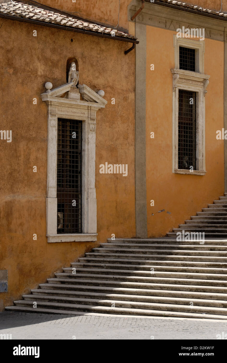 Rome. Italy. Rustic wall with windows lining a staircase that descends ...