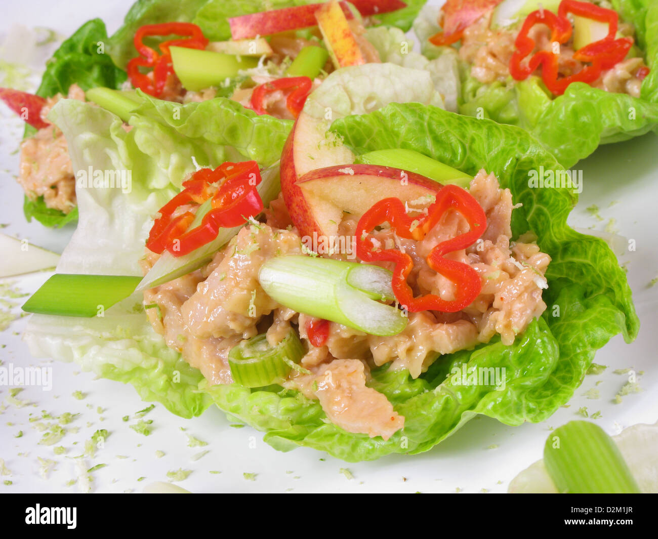 Canapes of spicy Coronation chicken in lettuce boats with sliced