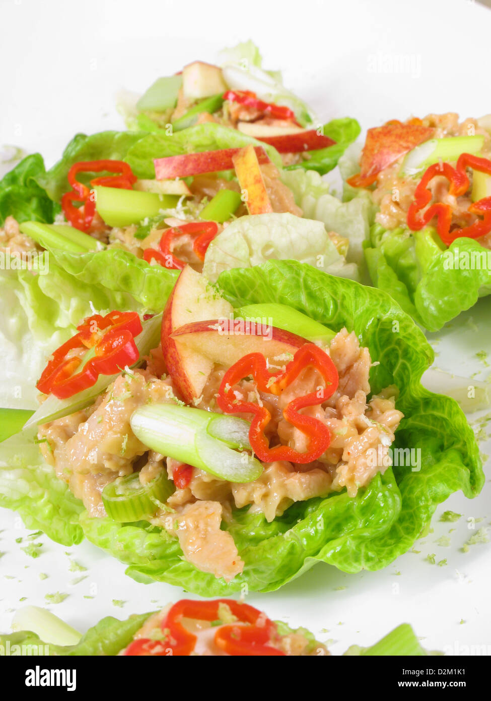 Canapes of spicy Coronation chicken in lettuce boats with sliced