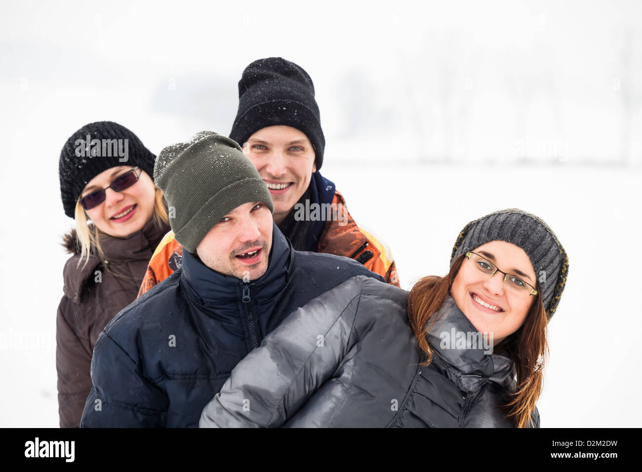 Group of young happy friends enjoying snow and winter. Stock Photo