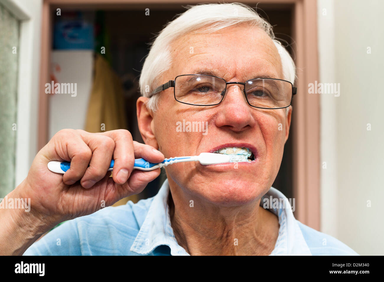 Close up of senior man brushing his teeth. Stock Photo