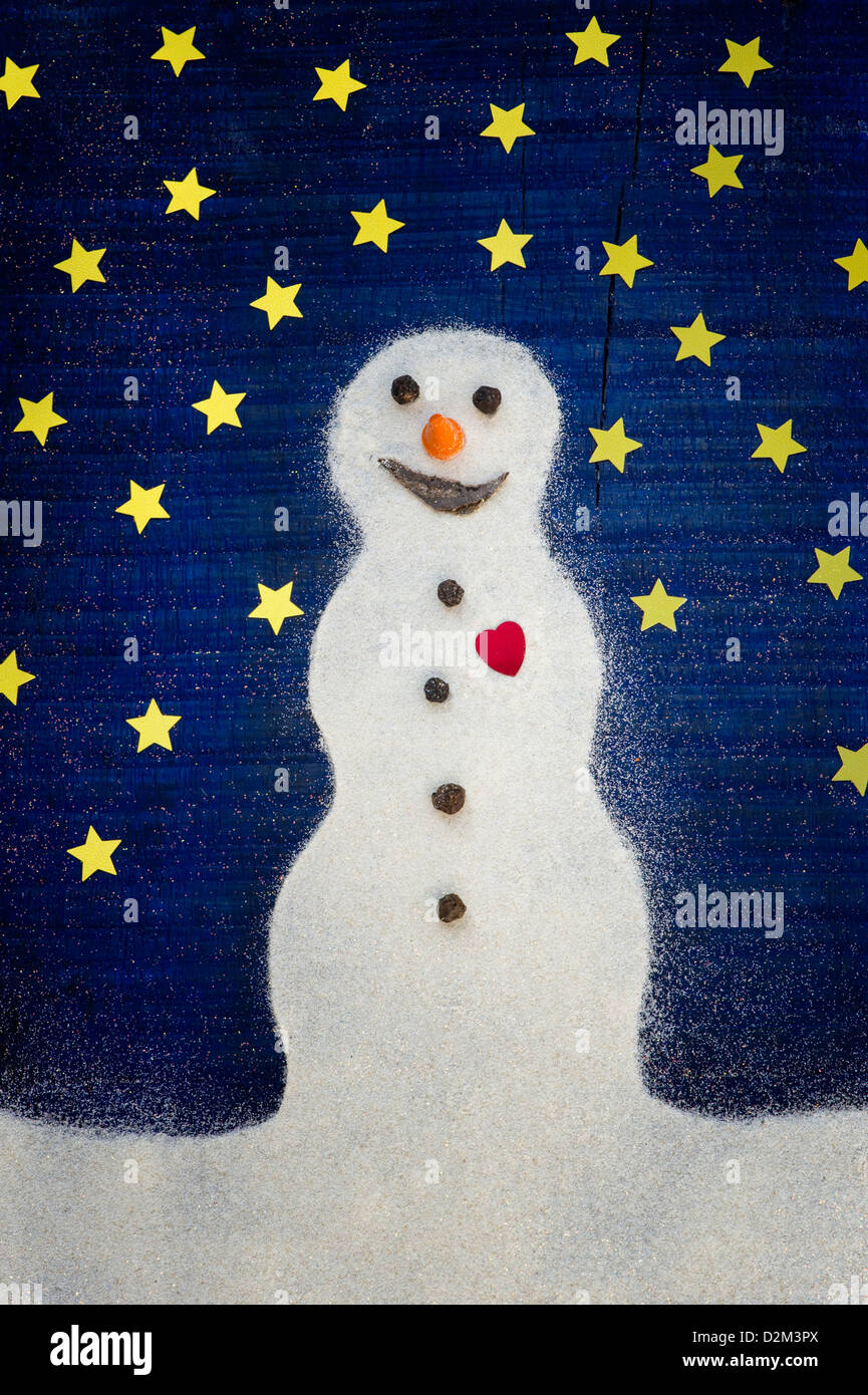 Snowman with a red heart in the snow against starry night sky concept Stock Photo