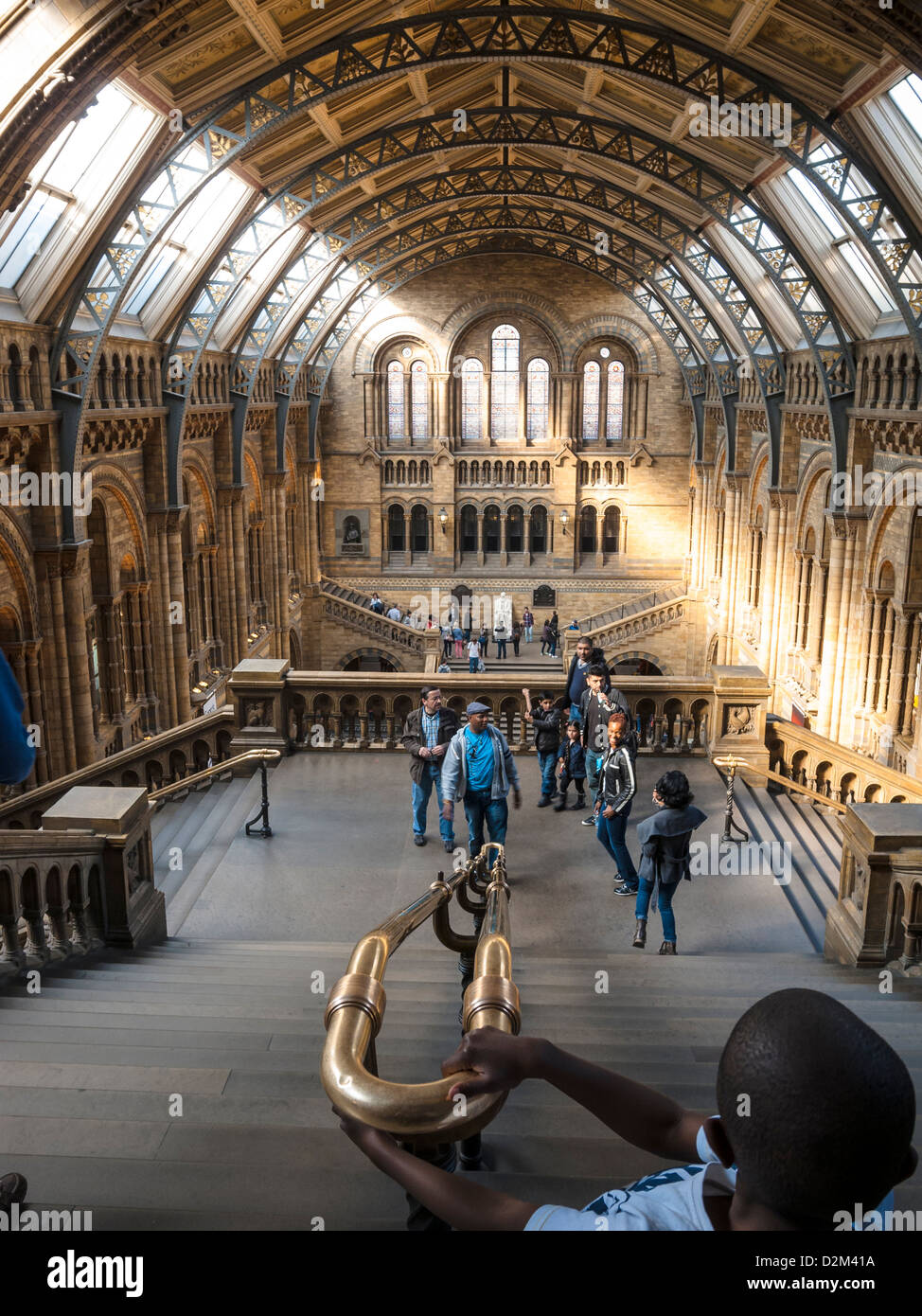 A boy on stairs of Natural history museum in London in a sunny day Stock Photo