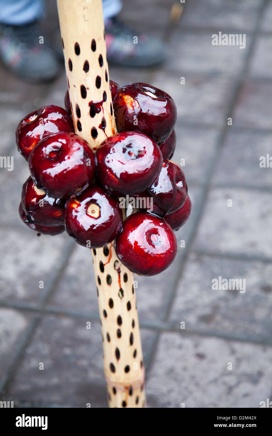 Vendor with Toffee Apples on Stick for sale over Day of the Dead in Oaxaca - Mexico Stock Photo