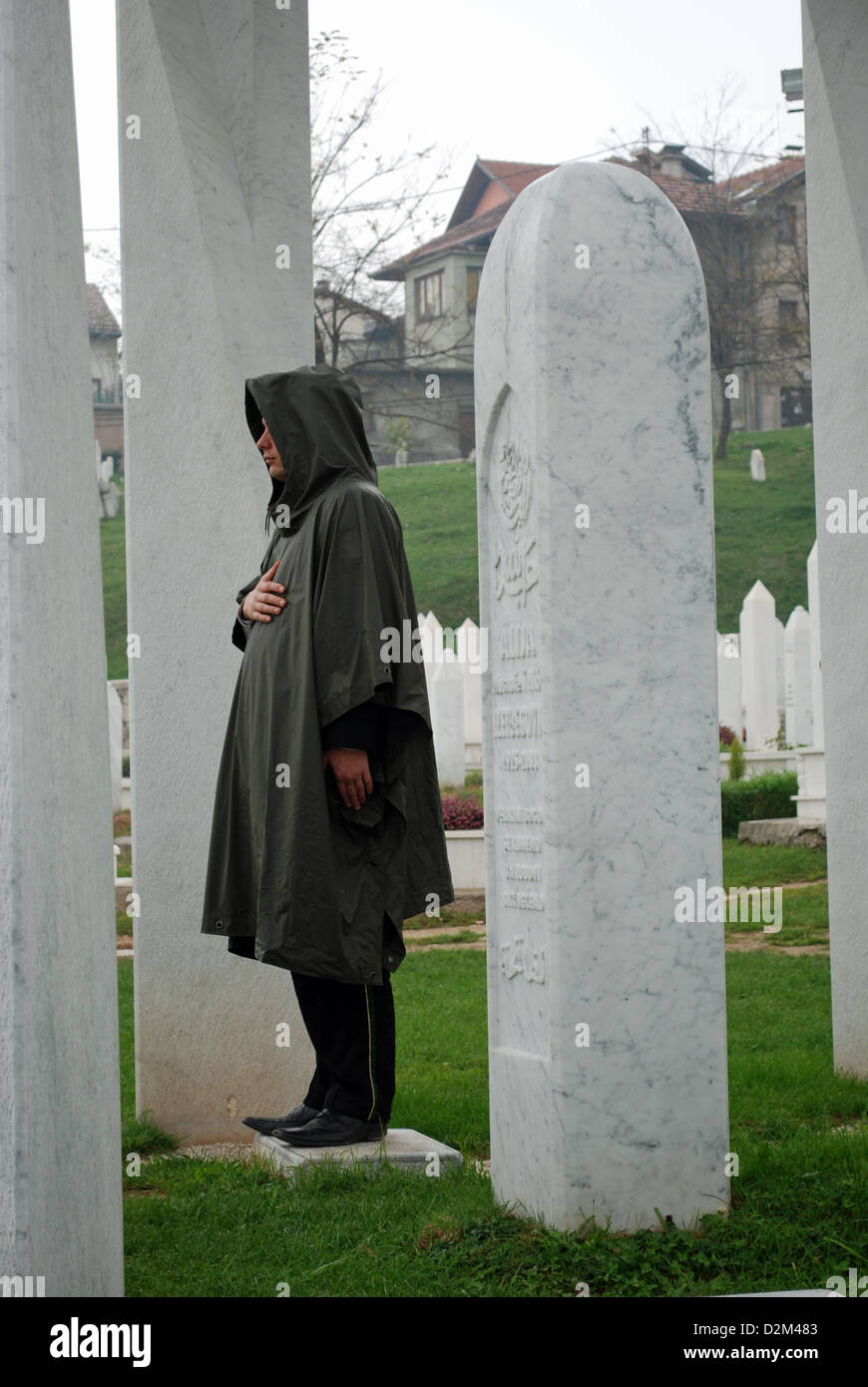 The grave of former Bosnian President Alija Izetbegović guarded by a soldier. The grave was damaged by a bomb attack in 2006. Stock Photo
