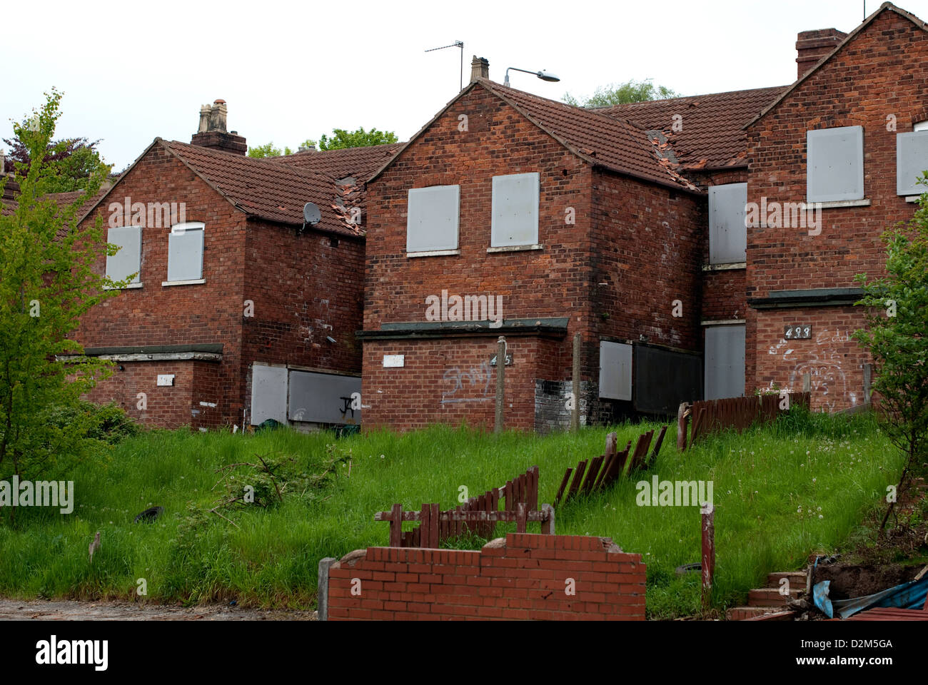 A row of former colliery homes boarded up and ready for demolition at Pleasley, Mansfield, North Nottinghamshire. Stock Photo