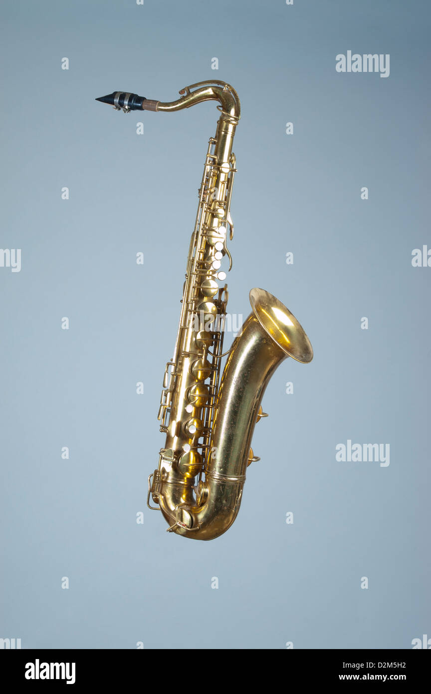 A shiny tenor saxophone, keys with pearl inlay, shot on a blue