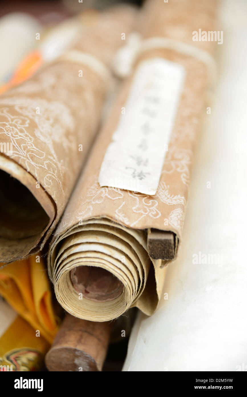 Collection of multiple Chinese scroll rolled together on the cabinet. Shanghai, China. Stock Photo