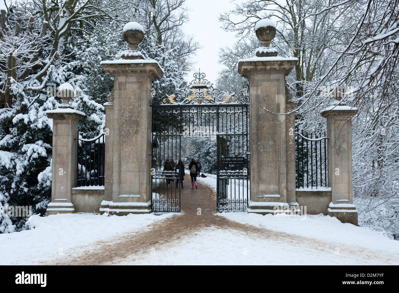 The ornate gates at the rear entrance to Clare College Cambridge Queens Road Cambridge UK in snow. Stock Photo
