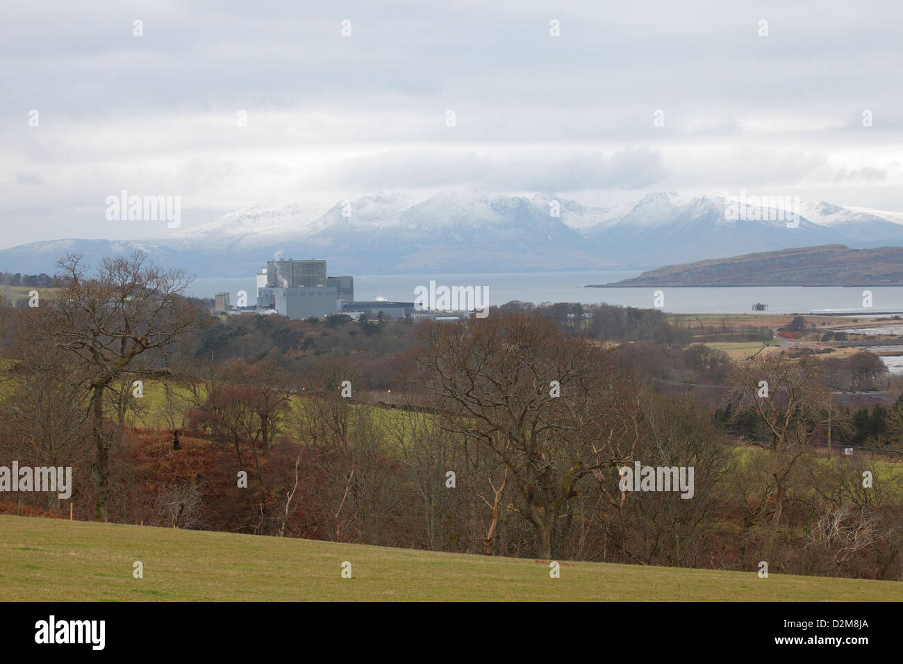 Hunterston B Nuclear Power Station near Largs in Ayrshire with snow caped Isle of Arran in the background. Stock Photo