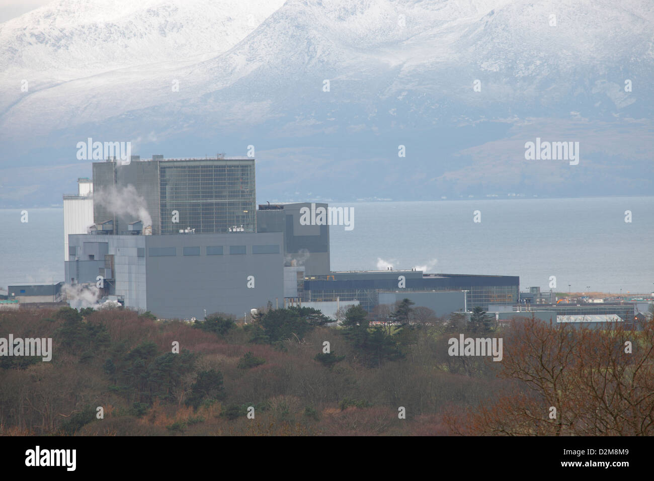 Hunterston B Nuclear Power Station near Largs in Ayrshire with snow caped Isle of Arran in the background. Stock Photo