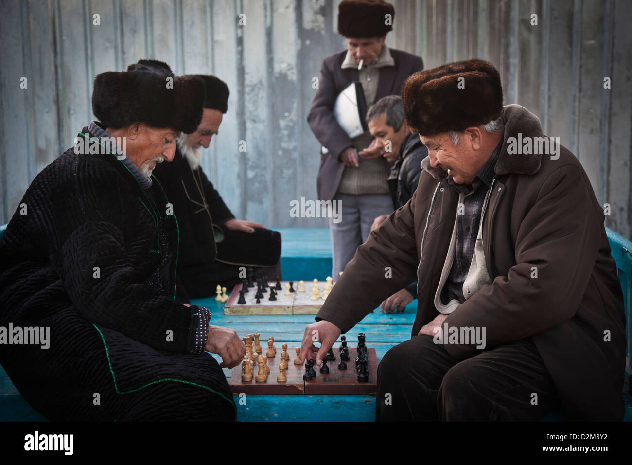 Old Tajik and Uzbek pensioners play chess in a park near Hissor bazaar, in Tajikistan. Stock Photo