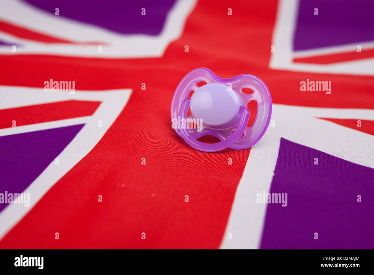 Symbolic picture of a pink pacifier on the british flag Stock Photo Alamy