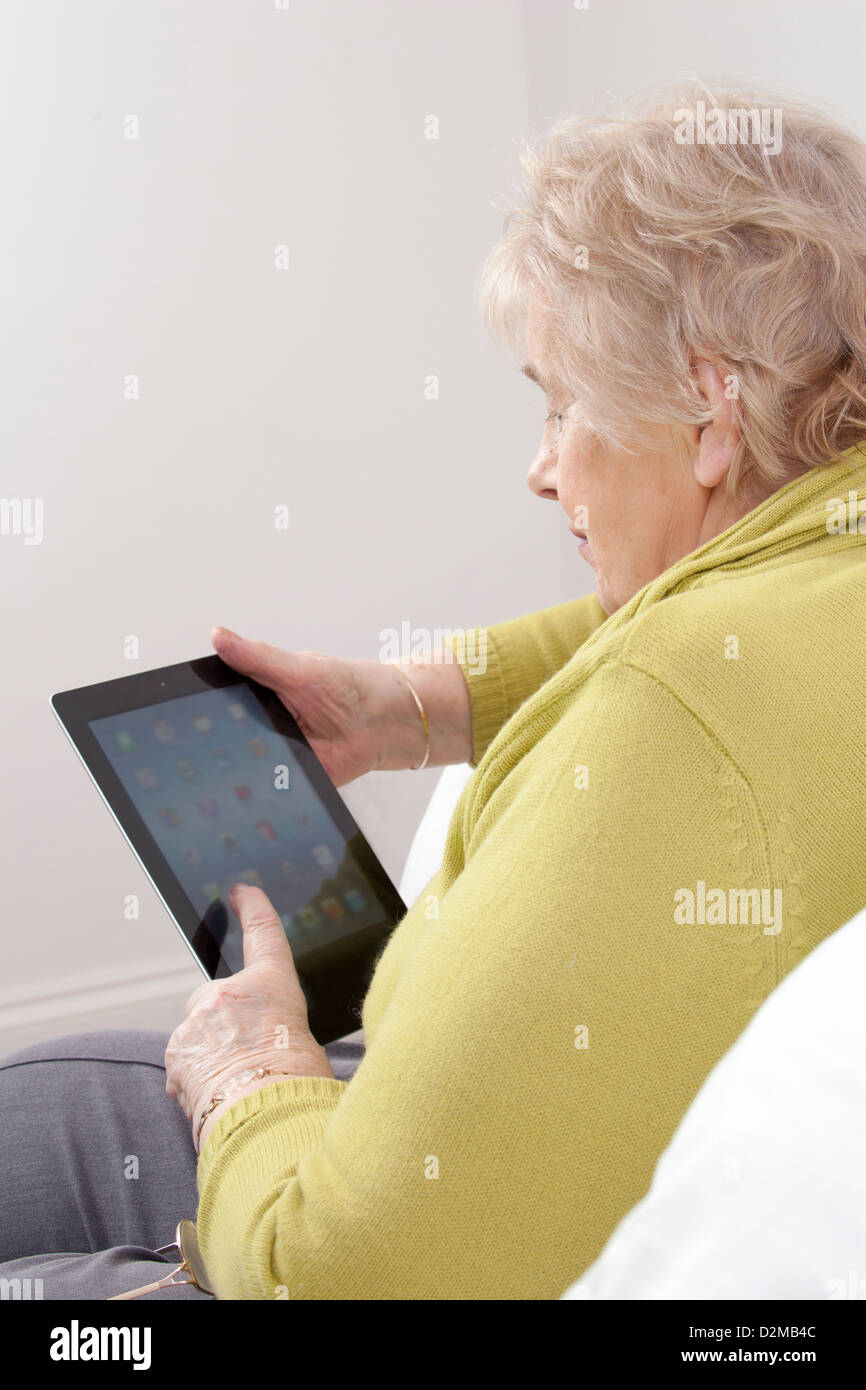 Mature lady using a digital tablet. Stock Photo