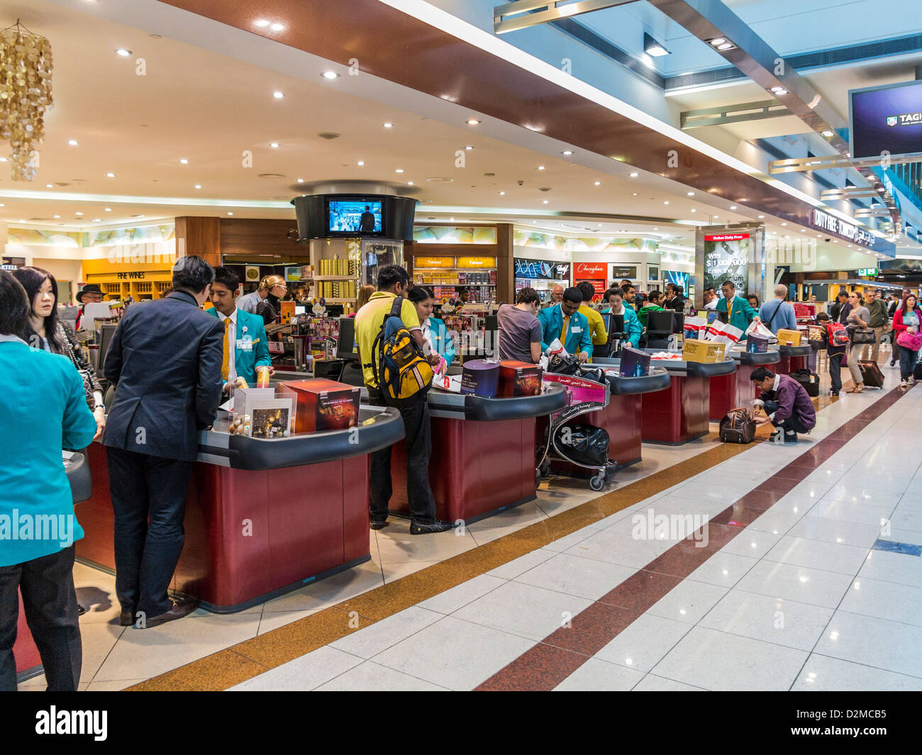 People and passengers shopping and queuing to buy goods at the Duty Free shop checkouts at Dubai Airport Stock Photo