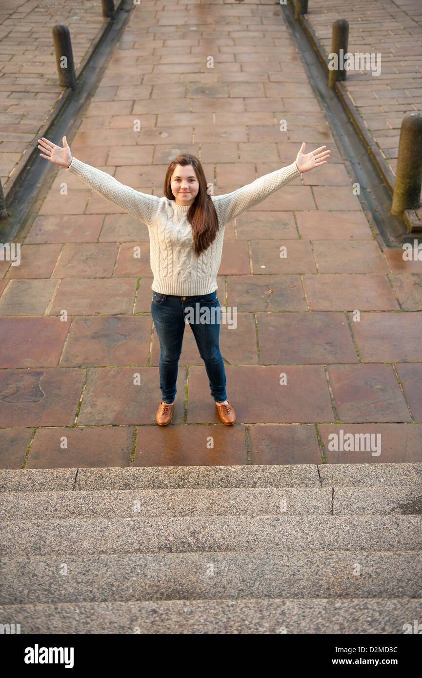Girl standing with her arms stretched out hi-res stock photography
