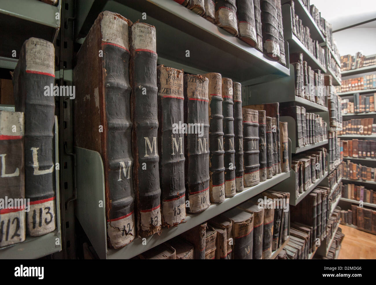 Aged old books in rows on focus, blur, bookshelf, monastery museum
