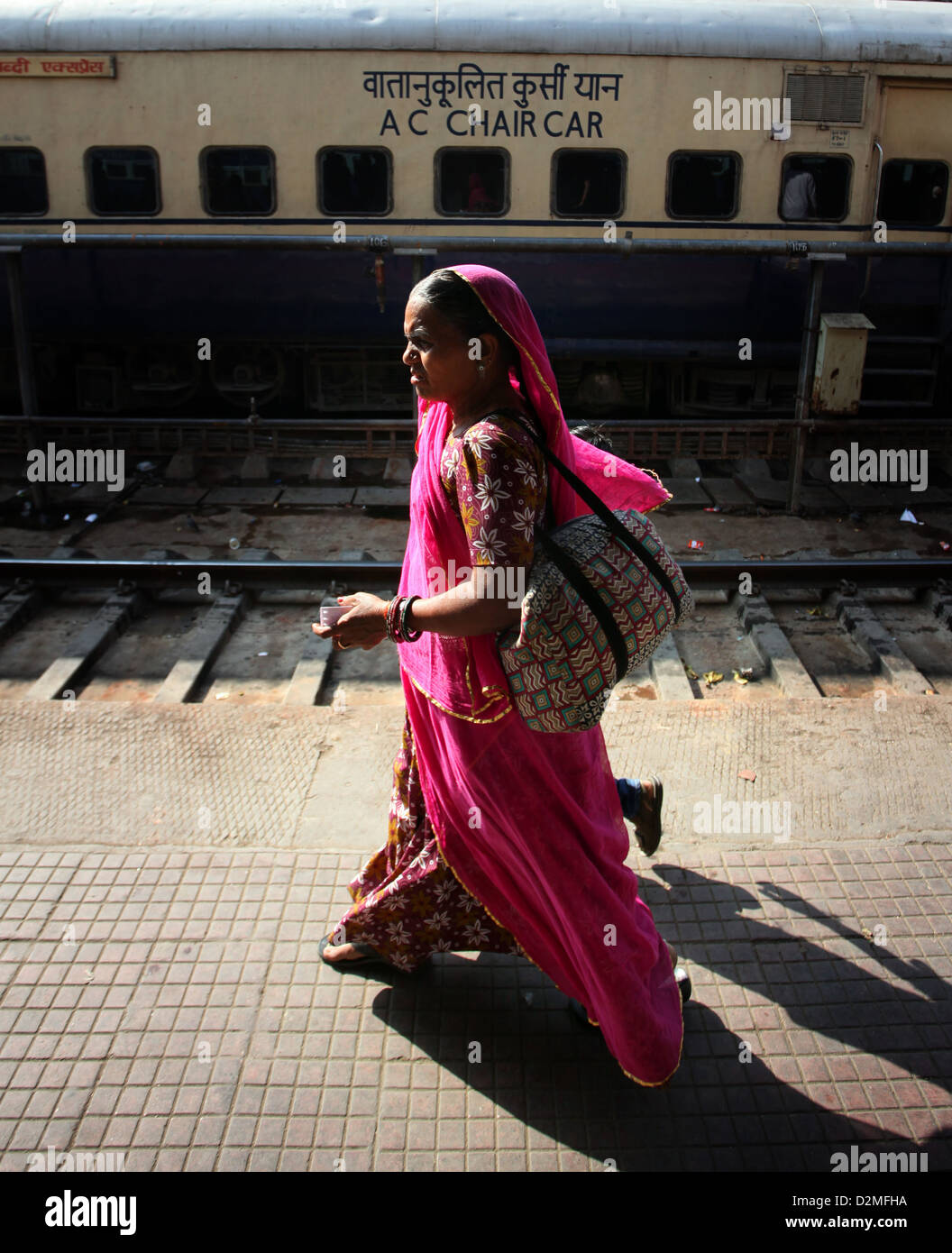 General view of a woman walking along the platform of Ajmer railway station in Rajasthan, India Stock Photo