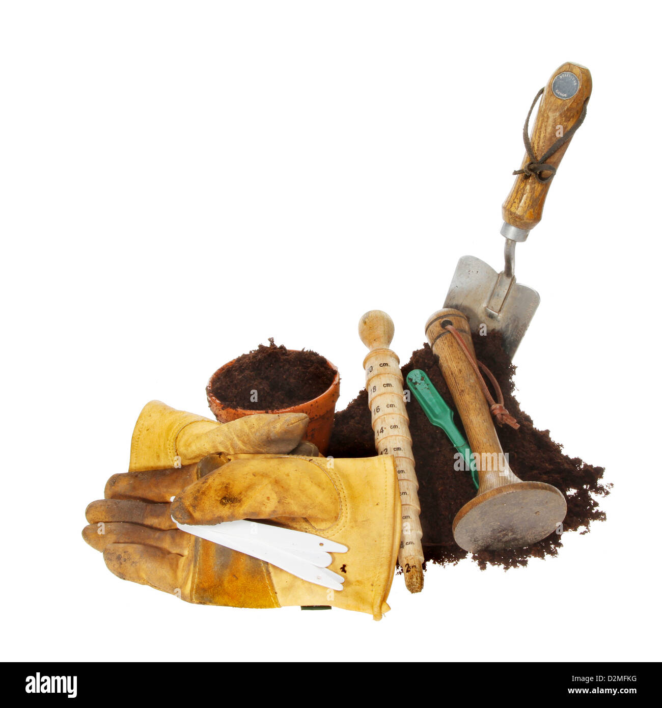 Garden tools around a pile of soil isolated agaunst white Stock Photo