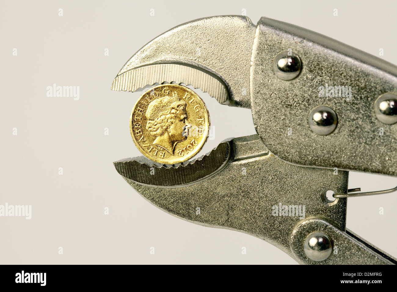 A british one pound coin in a wrench to illustrate the concept of the pound being under pressure, UK Stock Photo