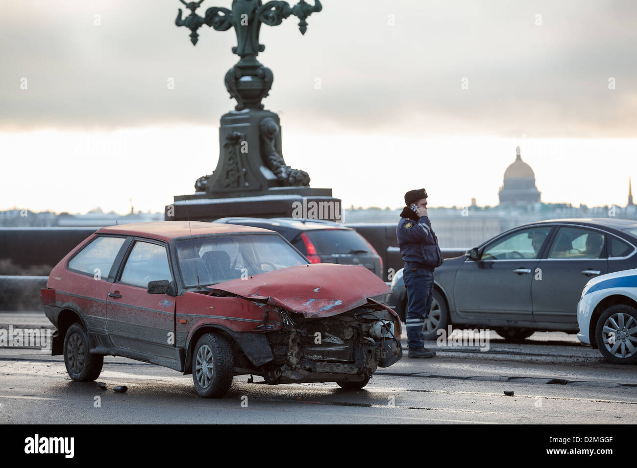 Crashed car after frontal impact is on city street with police in Saint-Petersburg, Russia. Driving oncoming traffic lane. Stock Photo